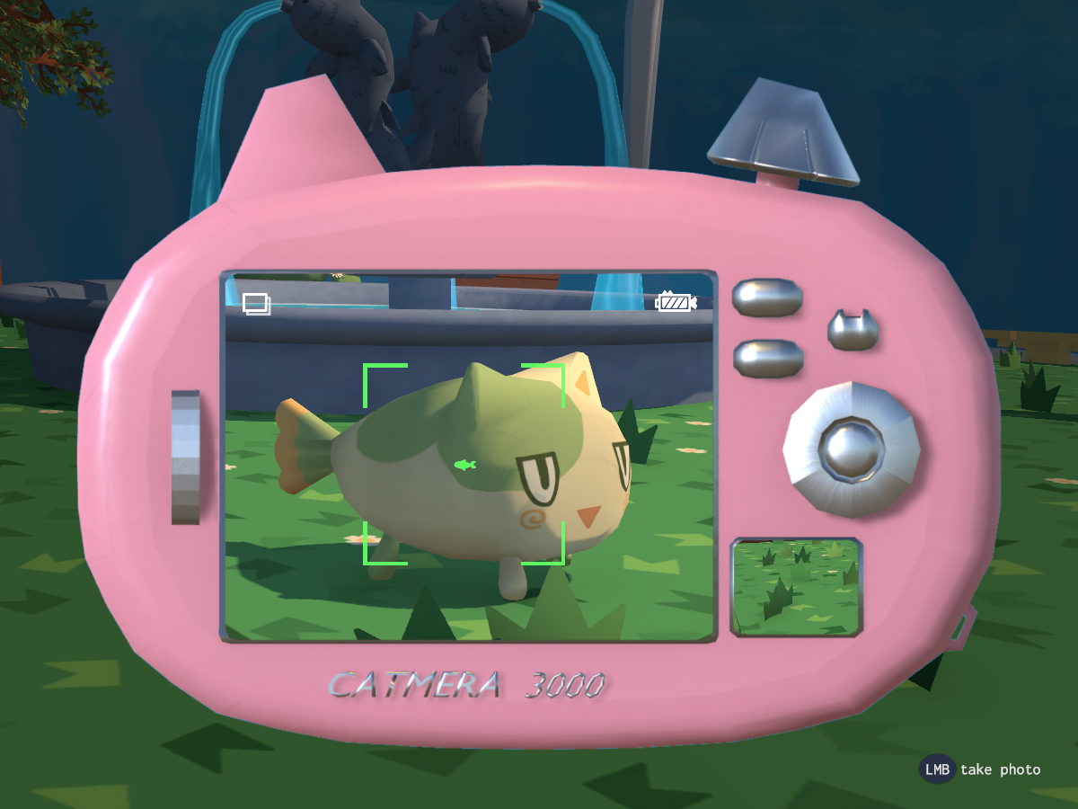 Pink cat eared camera showing a green and cream colored fish cat.